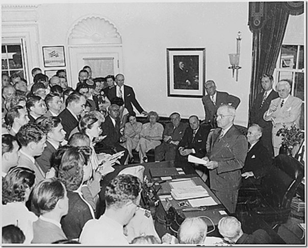 President Truman in the Oval Office, reading the announcement of Japan's surrender